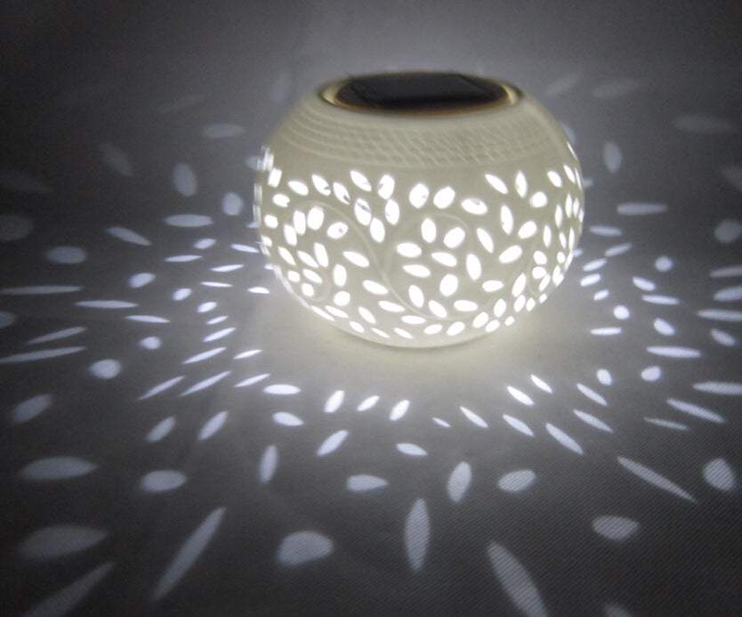 European style LED night light with decorative soft white light pattern and solar panel on top