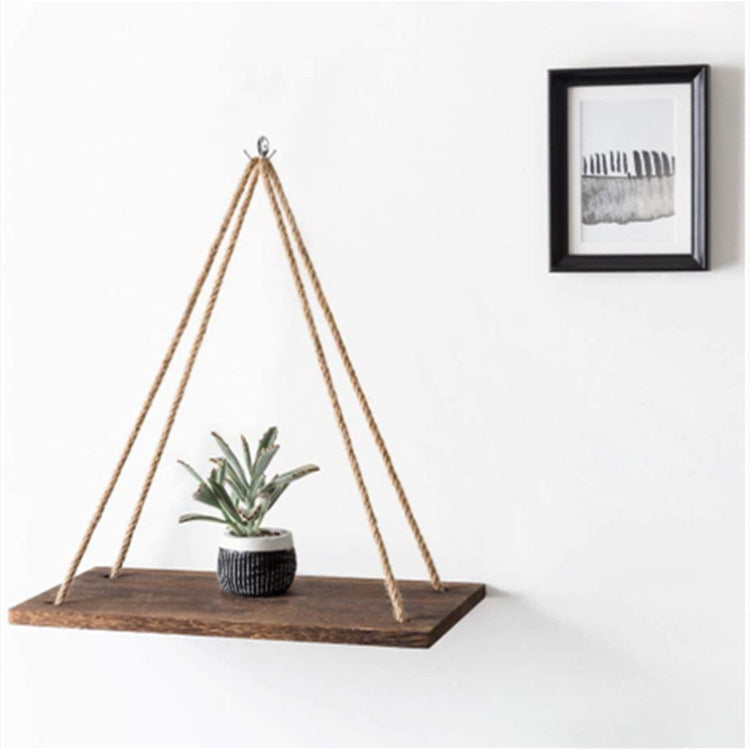Wooden wall floating display rack with hanging rope and small potted plant on dark wood shelf in modern decor